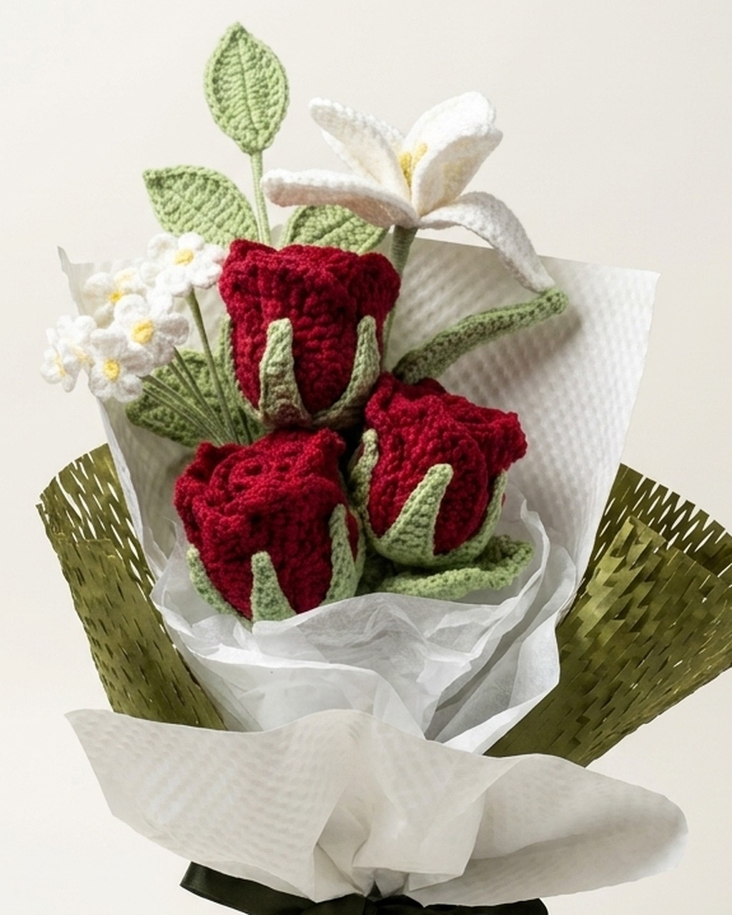 Close-up of yarn stitches and flower details on handmade deep red crochet rose and white lily bouquet